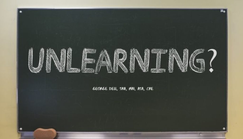 Unlearning? by George Dell, SRA, MAI, ASA, CRE on a blackboard written in chalk
